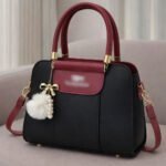 Elegant Dual Tone Handbag With Pom Pom Charm