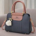 Elegant Dual Tone Handbag With Pom Pom Charm