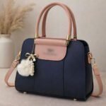 Elegant Dual Tone Handbag With Pom Pom Charm